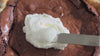 Spreading homemade whipped cream on a Chocolate Chess Pie